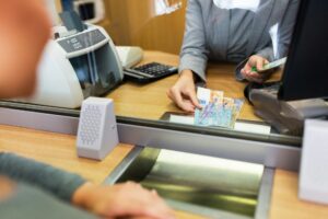 clerk counting cash money at bank office